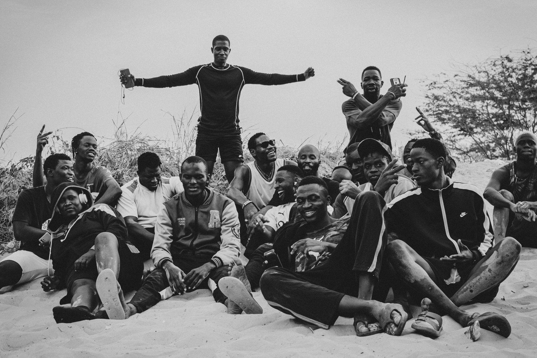 The whole wrestling school sitting together in the sand